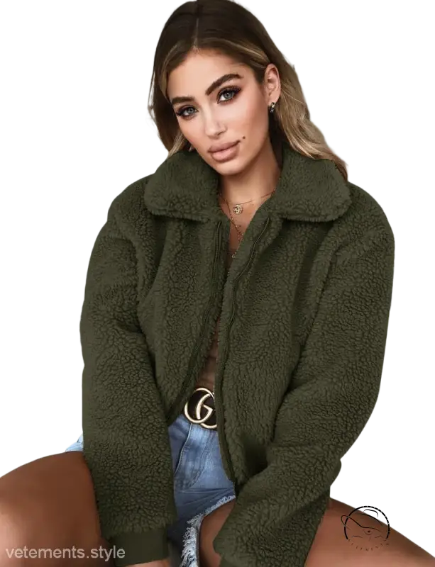 Army green teddy coat with large collar over denim shorts