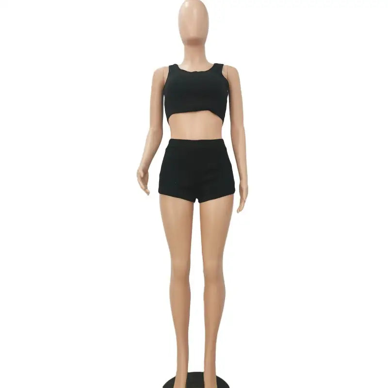 Black casual sports set featuring a sleeveless crop top and shorts on a mannequin