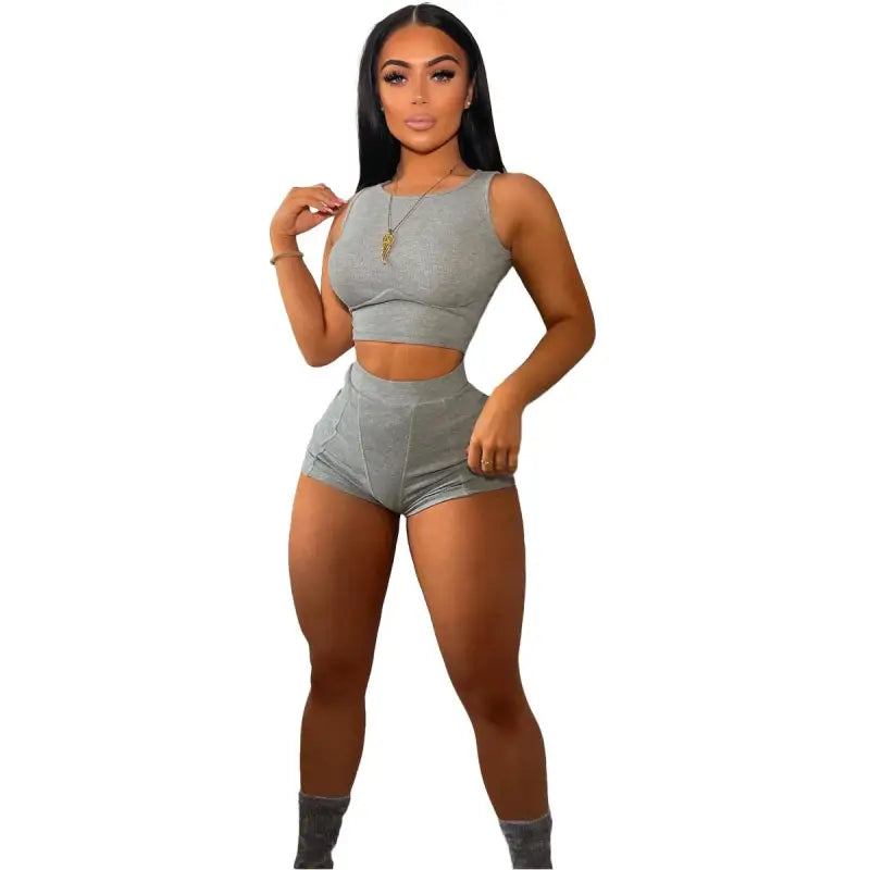 Woman modeling light gray ribbed casual sports set with crop top and shorts for summer wear
