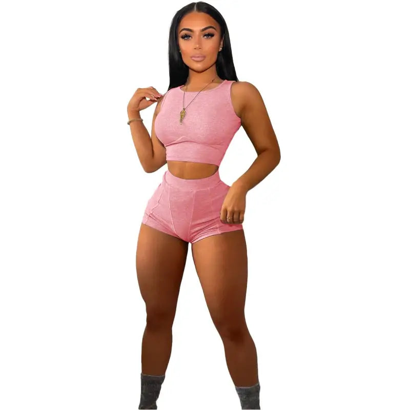 Pink two-piece casual sports set with sleeveless crop top and high-waisted shorts