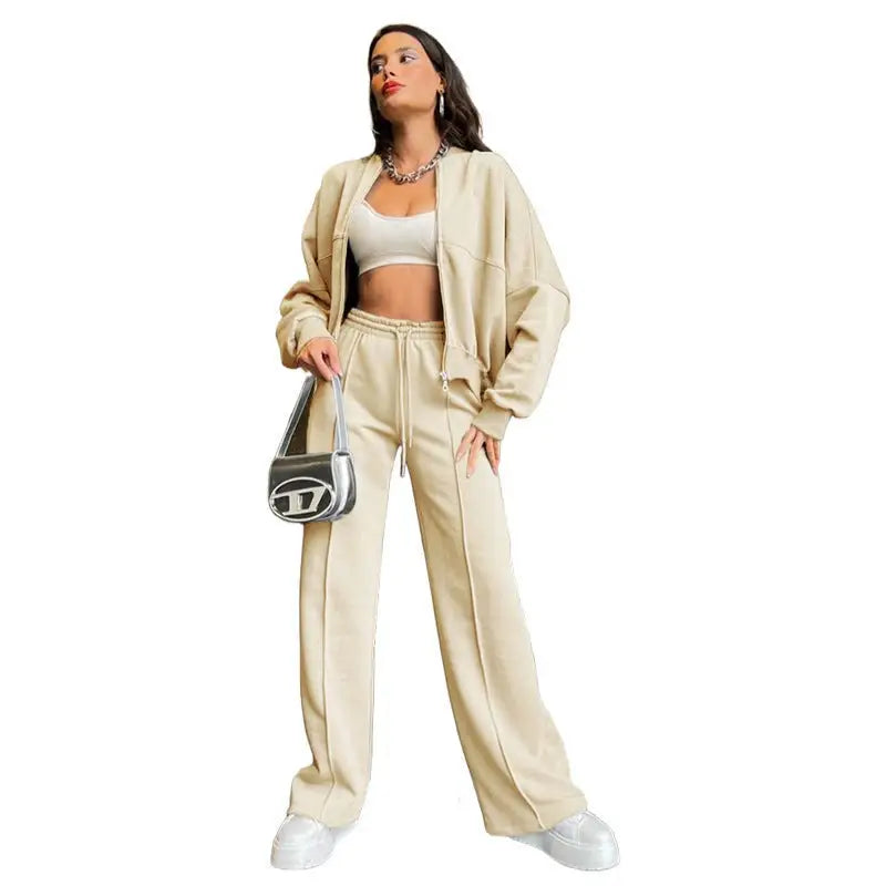 Woman in beige tracksuit featuring a zipper cardigan sweater and casual straight pants