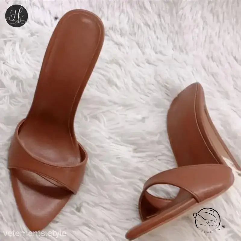 Pair of brown leather stiletto pumps in chic summer slide style