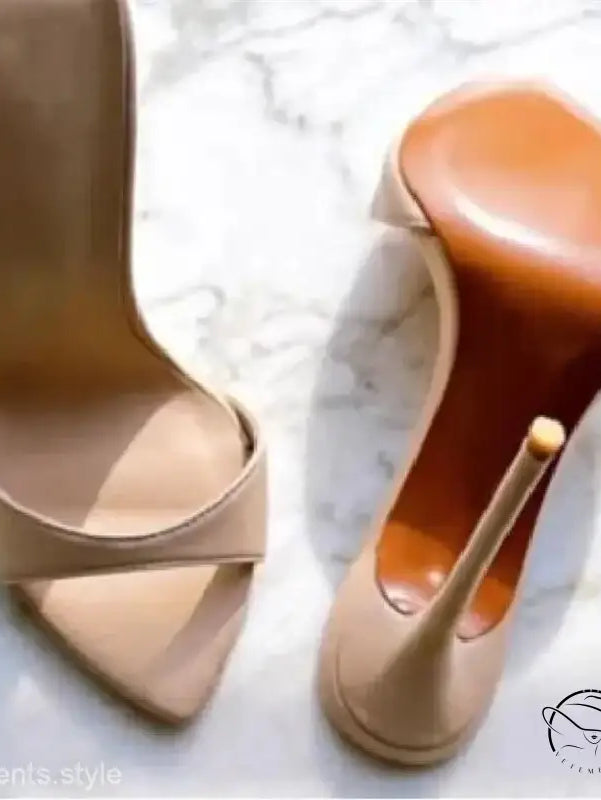 Pair of nude stiletto pumps with crossed straps in chic summer slide style