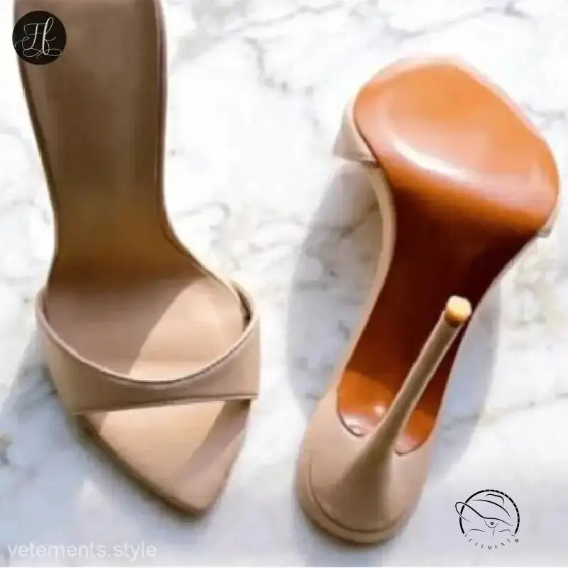 Pair of nude stiletto pumps with crossed straps in chic summer slide style