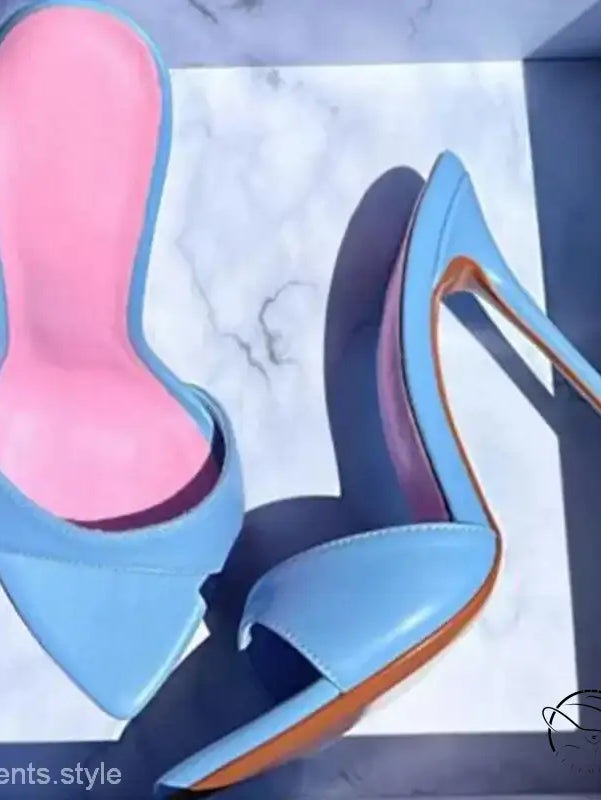 Pair of light blue stiletto pumps with pink insoles, chic summer slide style