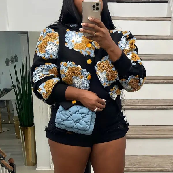 Rose red Chrysanthemum floral print jacket with blue quilted leather purse on black background