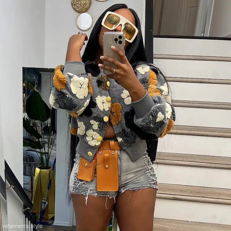 Rose red chrysanthemum floral print cardigan with oversized buttons and fur trim on gray background