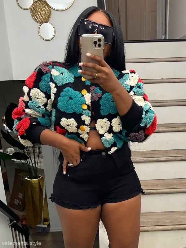 Rose red chrysanthemum floral print jacket with pom-pom sweater and black shorts