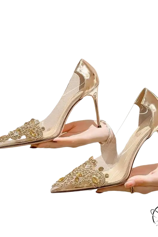 Pair of transparent classic stiletto high heels with gold rhinestone toes