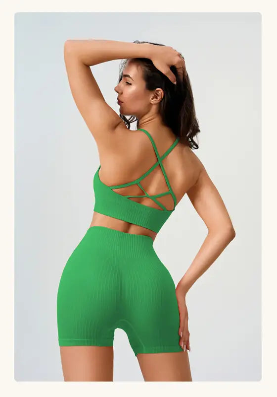 Woman in green ribbed workout set showcasing Comfy High Waist Yoga Shorts in Peach Blossom Pink and Dark Coffee Color