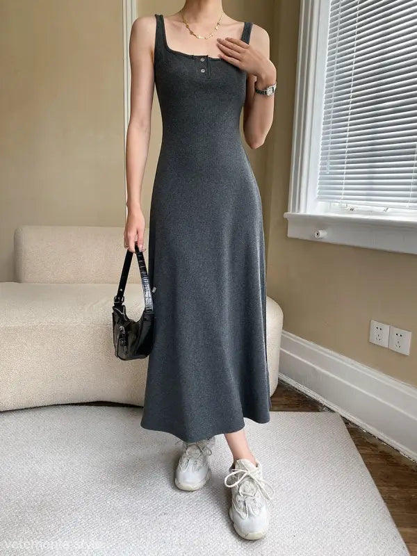 Long dark gray sleeveless slim outdoor dress with fitted bodice and flared skirt