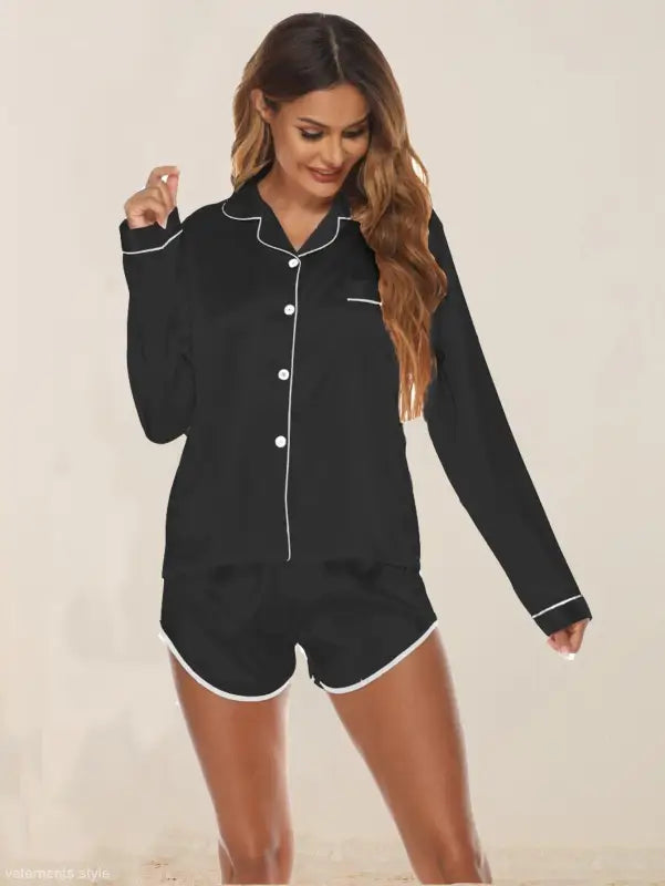 Black silk shorts pajamas with white piping, long-sleeved top and matching shorts