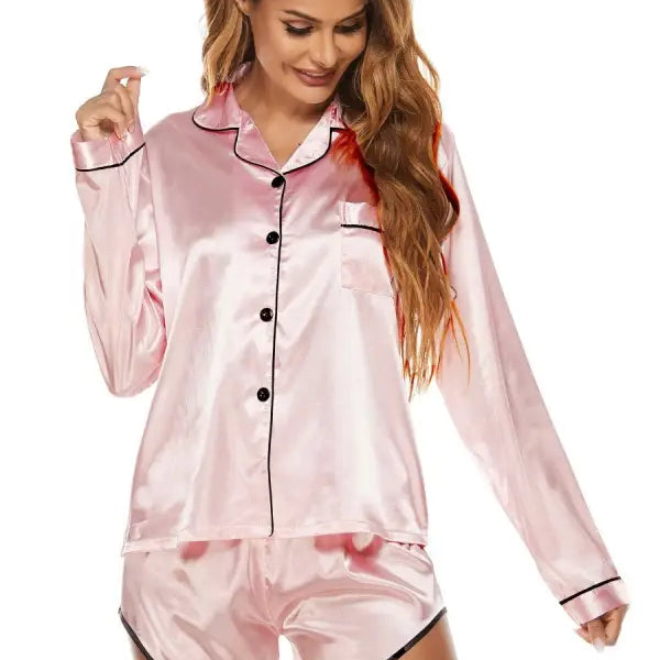 Pink satin silk shorts pajamas with black piping, featuring long-sleeve button-up top