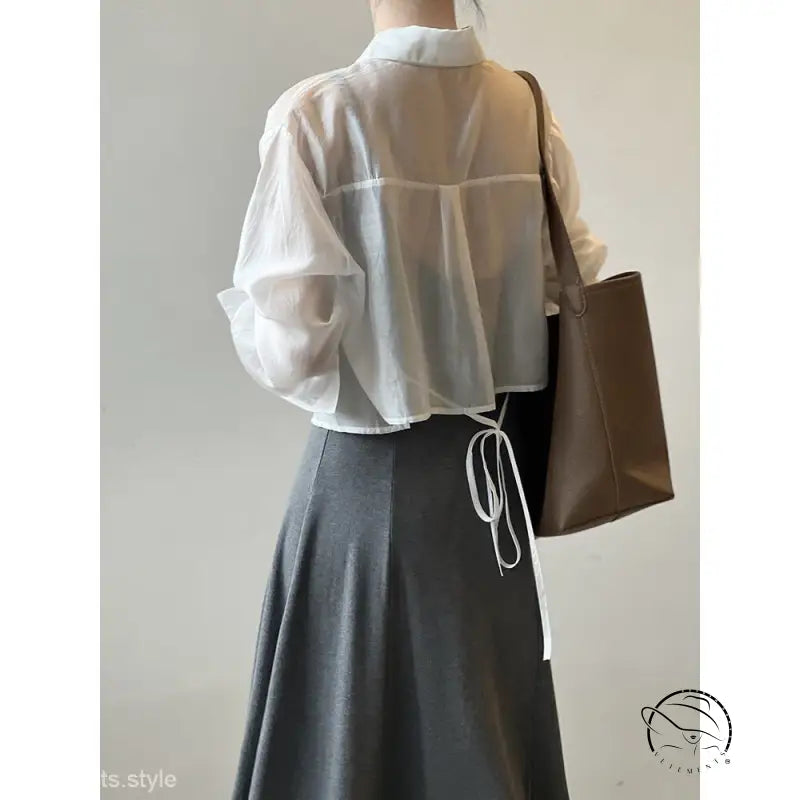 White blouse with billowy sleeves, black midi skirt in comfy sunrise cardigan set
