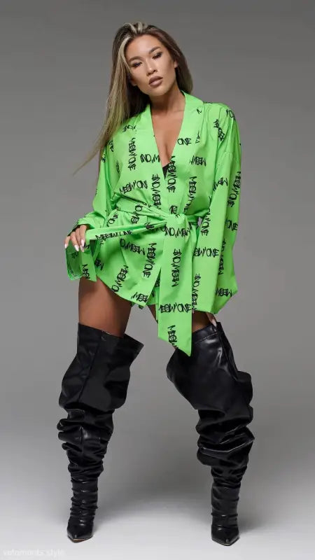 Woman in green robe and black boots showcasing comfy Vetements pajamas set with free shipping