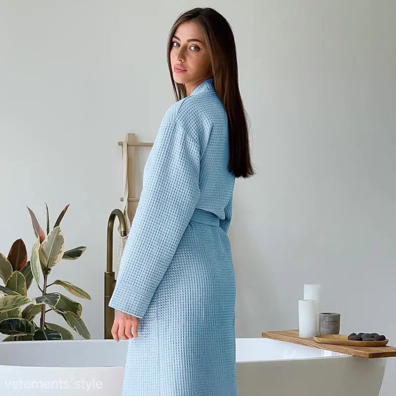 Light blue comfy waffle robe with belt and pockets worn by woman, ideal for long robe hotel stays
