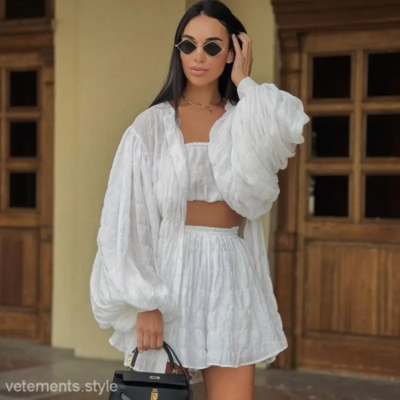 Woman in Comfy White Summer Three-Piece Set with Textured Button Top and oversized jacket
