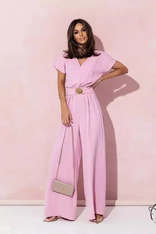 Woman wearing coral red casual trousers jumpsuit with short sleeves and wide-leg pants