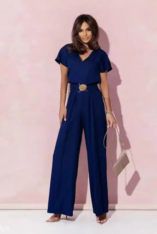 Woman wearing navy blue casual trousers jumpsuit with belt, ideal for stylish occasions