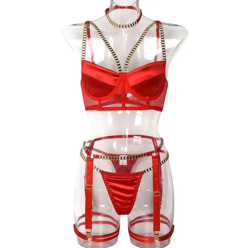 Coral red chain four piece lingerie set with bra, thong, and decorative straps on mannequin