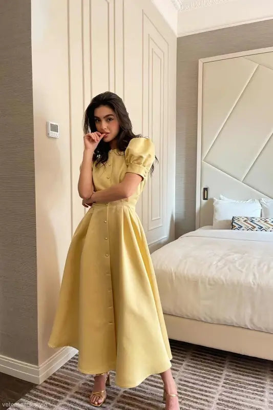 Yellow midi dress with puff sleeves and button-down front, perfect as a large swing line dress