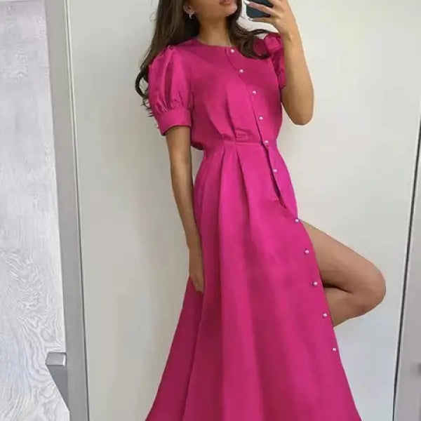 Vibrant coral red large swing line dress with puff sleeves and thigh-high slit