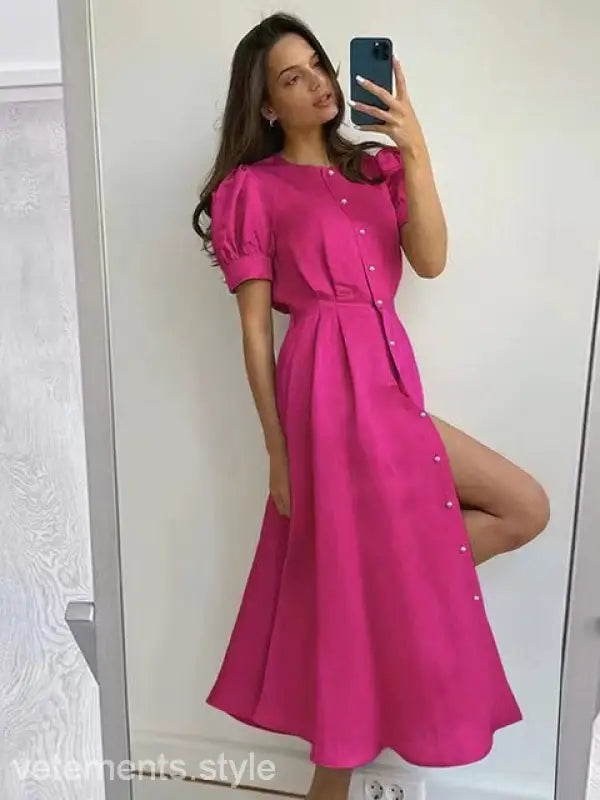 Vibrant coral red large swing line dress with puff sleeves and thigh-high slit