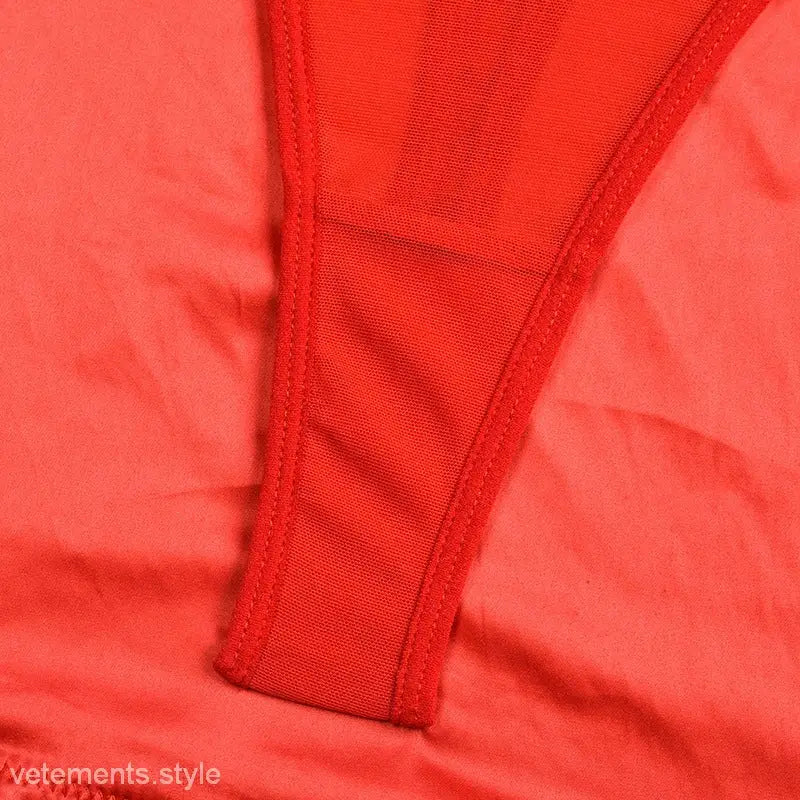 Coral red Polyester lingerie suit featuring a cutout design and thong styling