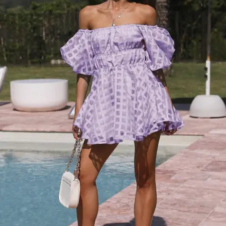 Off-the-shoulder lavender mini dress with puff sleeves and a checkered pattern.