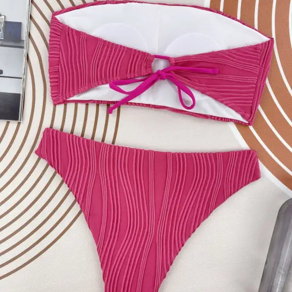 Hot pink textured three dimensional bikini with bandeau top and high-cut bottom for summer vacations