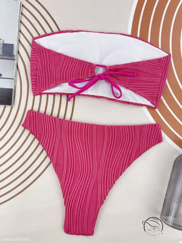Coral red three dimensional bikini swimsuit with hot pink textured bandeau top and high-cut bottom