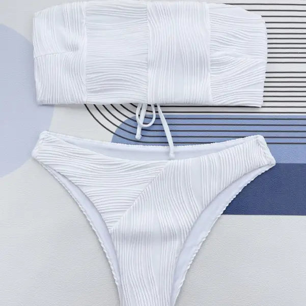 White textured three dimensional bikini swimsuit with bandeau top and high-cut bottom in coral red