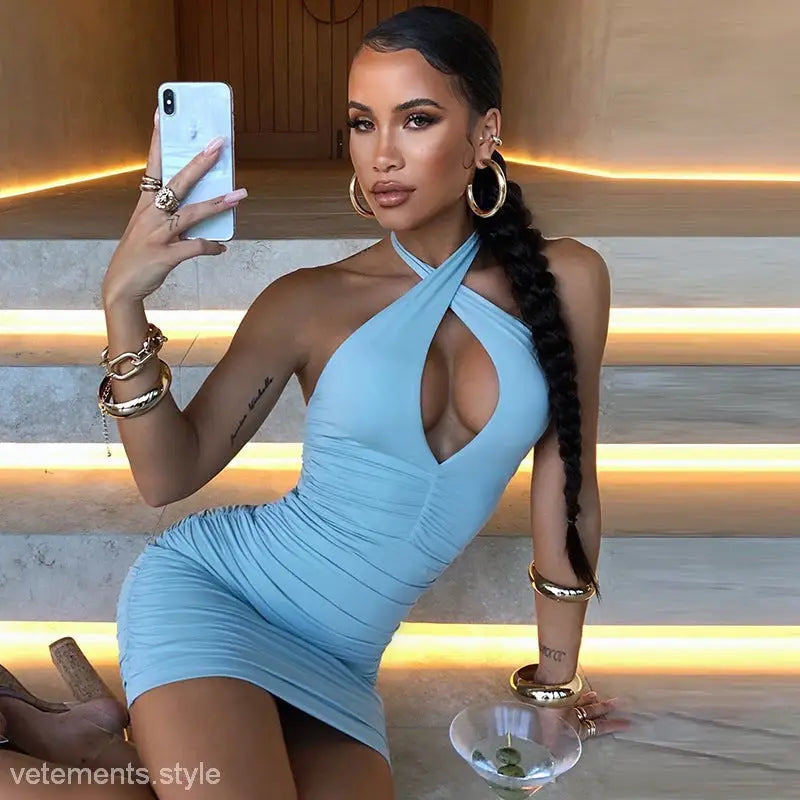 Light blue criss cross pleated halter mini dress displayed in Criss Cross Pleated Bodycon Dress