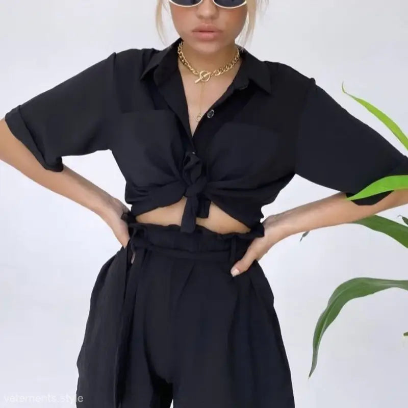 Black crop top and high-waisted pants in a cute casual beach set with accessories