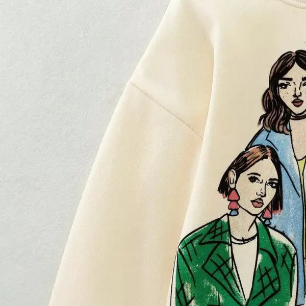 Cream-colored cute pattern sweater featuring graphic print of two stylized women in color outfits