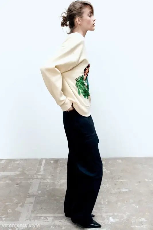 Woman modeling a Cute Pattern Sweater with a graphic design and long black skirt