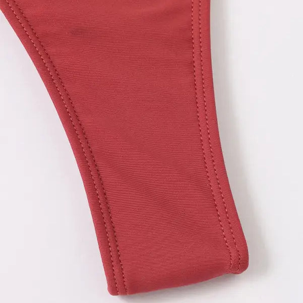 Red fabric strap with stitched edges.
