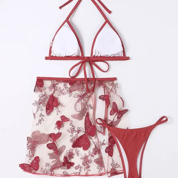 Red and white butterfly-patterned lingerie set consisting of a triangle bikini top, sheer skirt, and thong underwear.