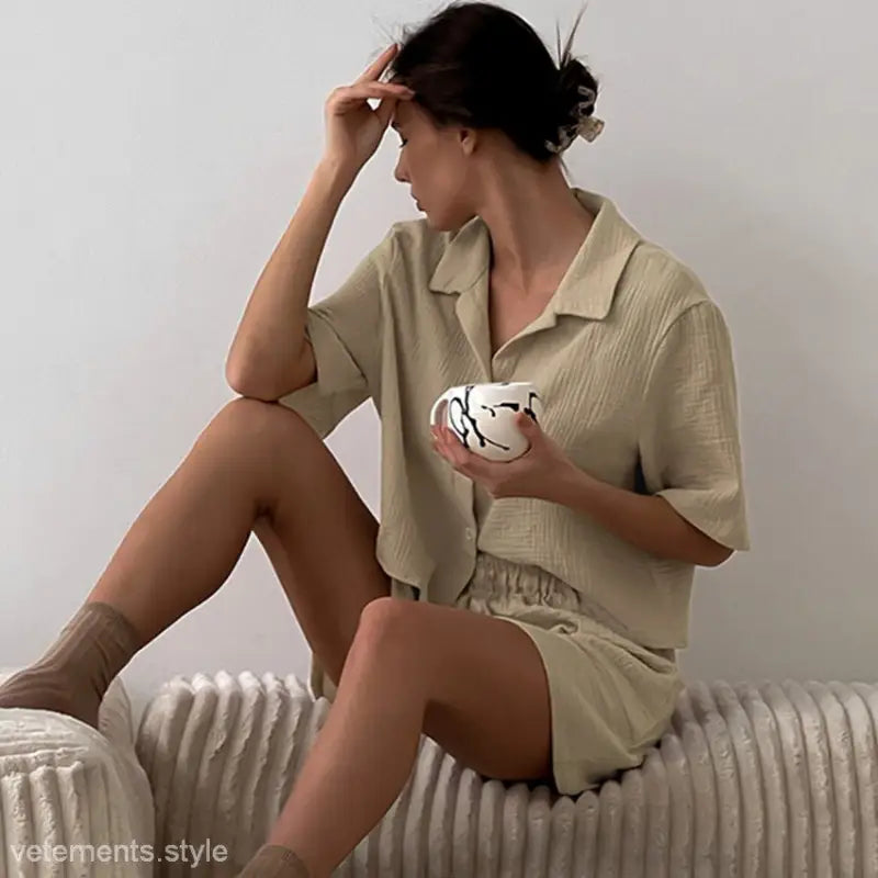 Woman in matching beige double layer gauze pajamas holding a mug for summer comfort