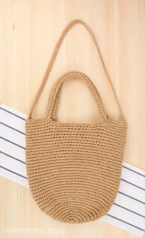 Handmade tan crocheted bohemian shoulder bag with essential care guidelines