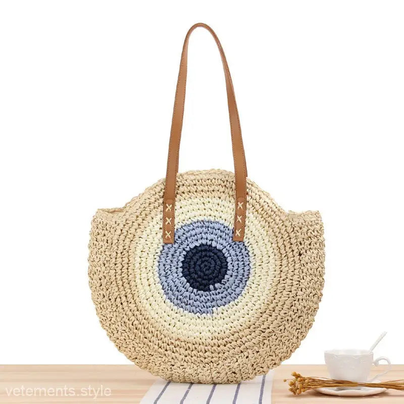 Woven straw beach bag with blue circular pattern, large striped blue design with leather handles