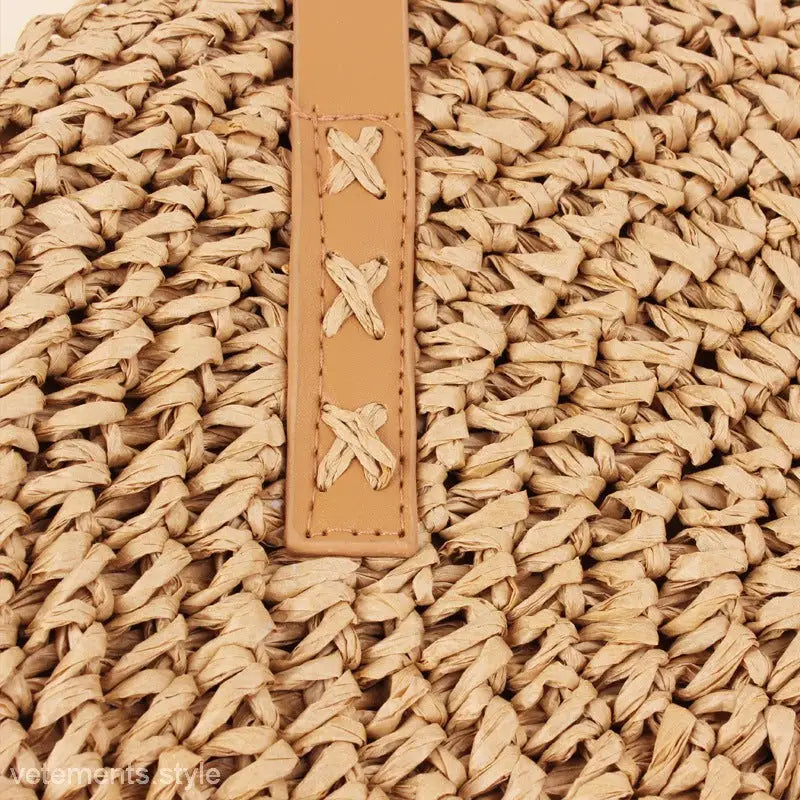 Woven straw bag with tan leather strap, part of the Large Striped Blue Cross Bohemian Bag