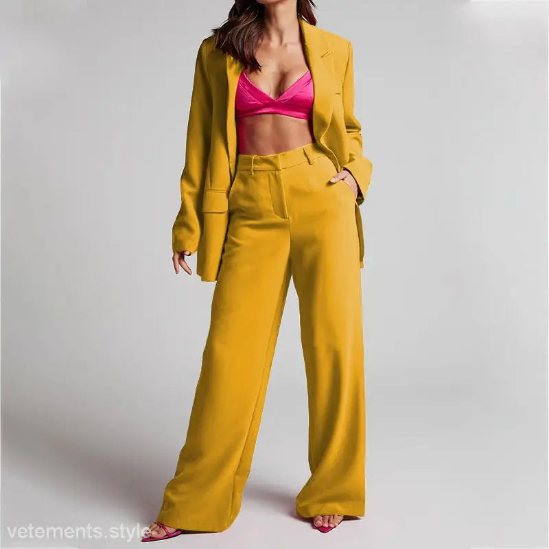 Woman wearing Edith Elegant Set, a spring collared high waist pantsuit with pink bra