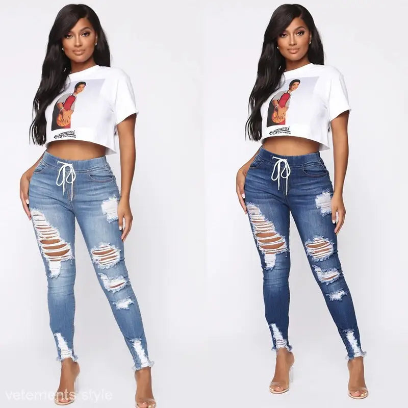 Two women model Elastic Ripped Skinny Hip Raise Jeans in stylish crop tops and ripped jeans