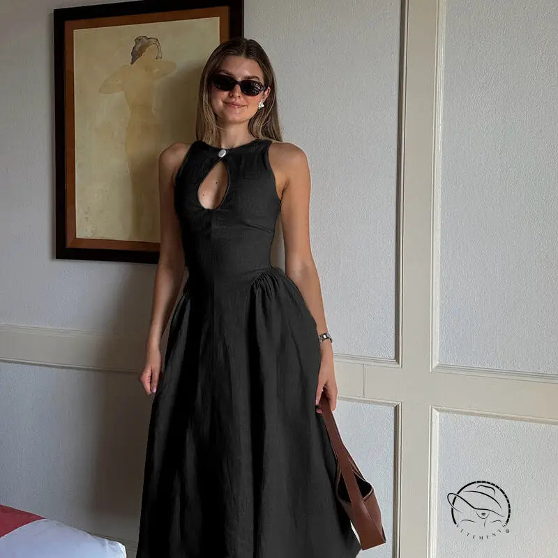 Woman in elegant A-line midi dress with crew neck, sleeveless black design and sunglasses