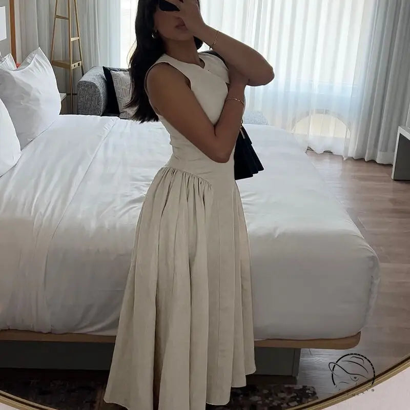 Woman in elegant A-line midi dress with crew neck sleeve for summer