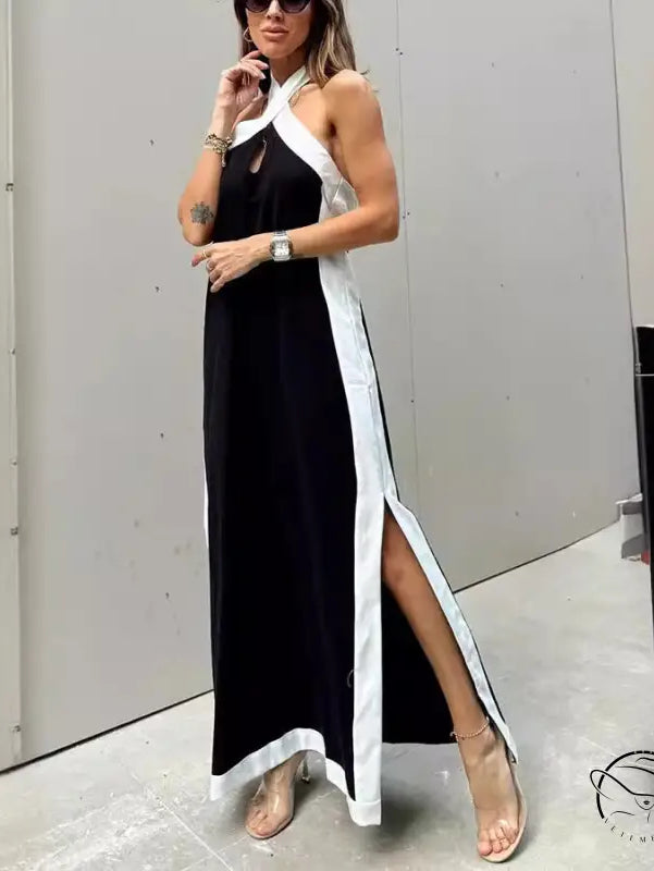 Long black and white halter-neck dress with a high side slit.