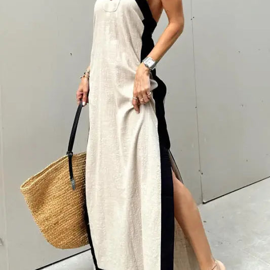 Long halter-neck maxi dress with contrasting black trim and side slit.