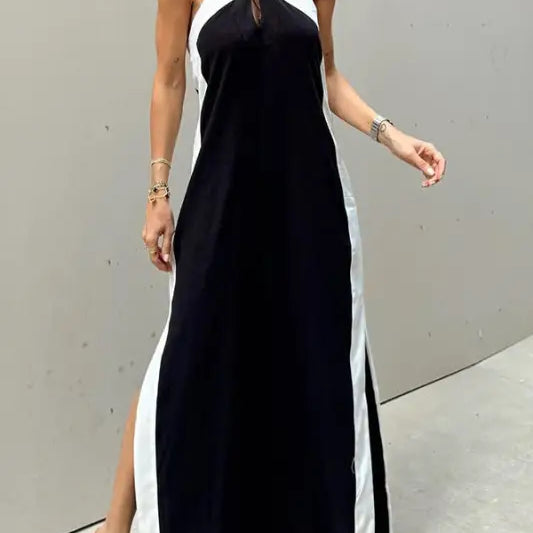 Black and white halter-neck maxi dress with side slits.