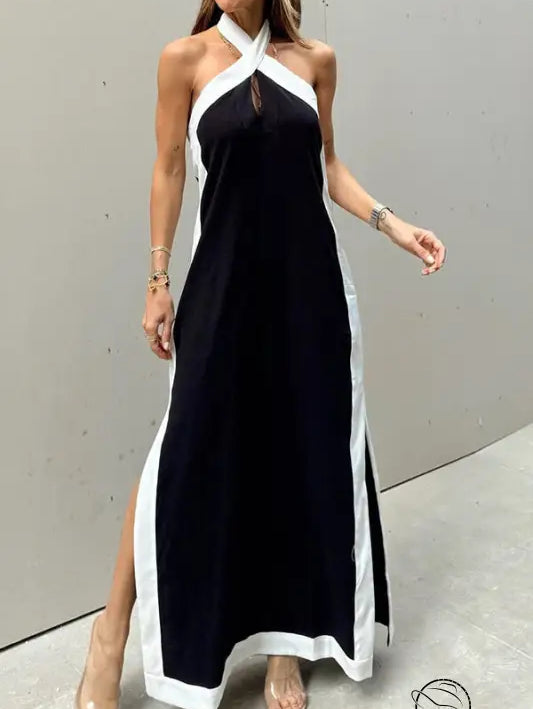 Black and white halter-neck maxi dress with side slits.